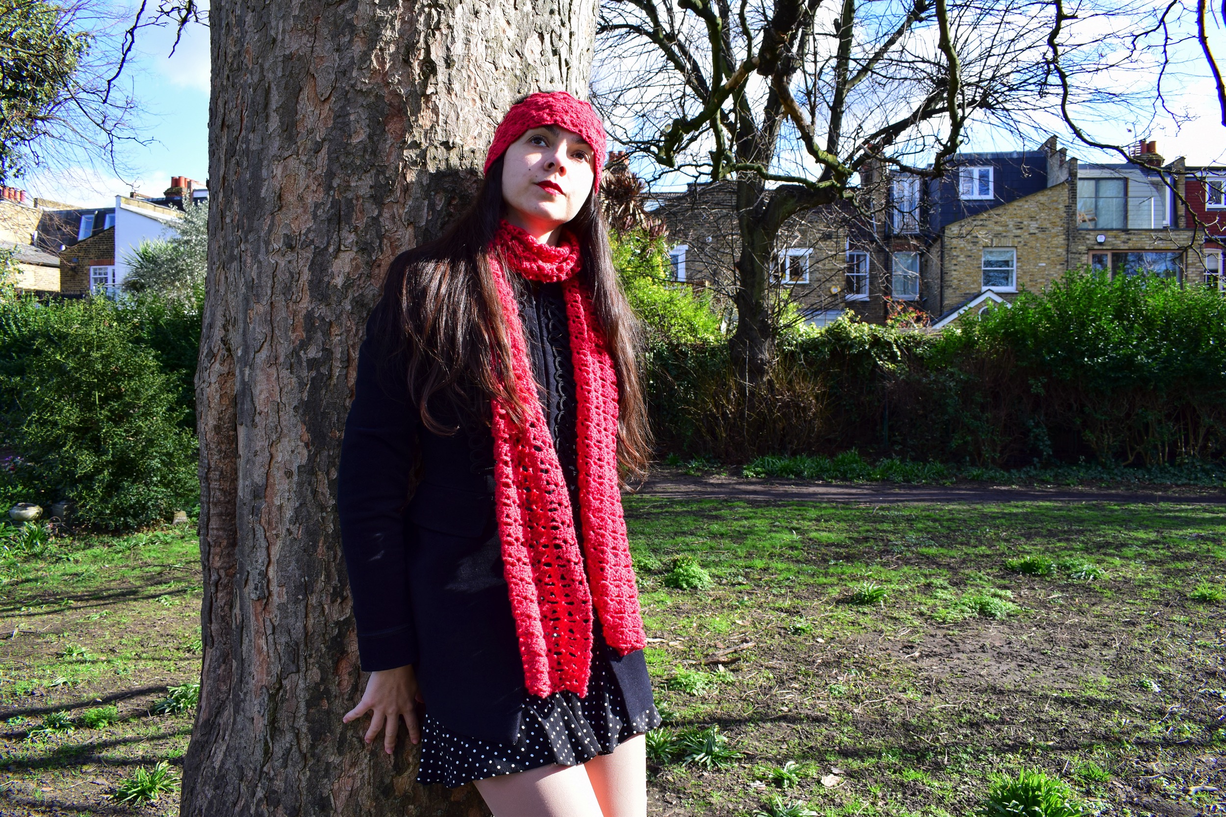 the picture links to a crochet project consisting of a red scarf with lace effect and a color-matching headband